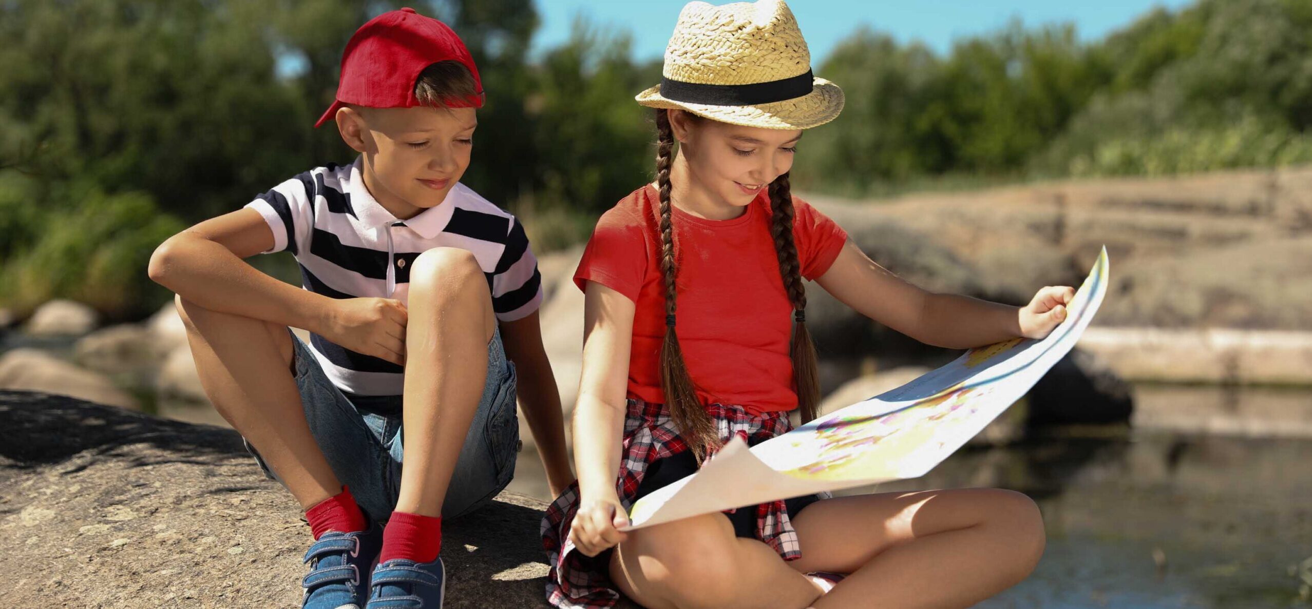Little children with map outdoors. Summer camp