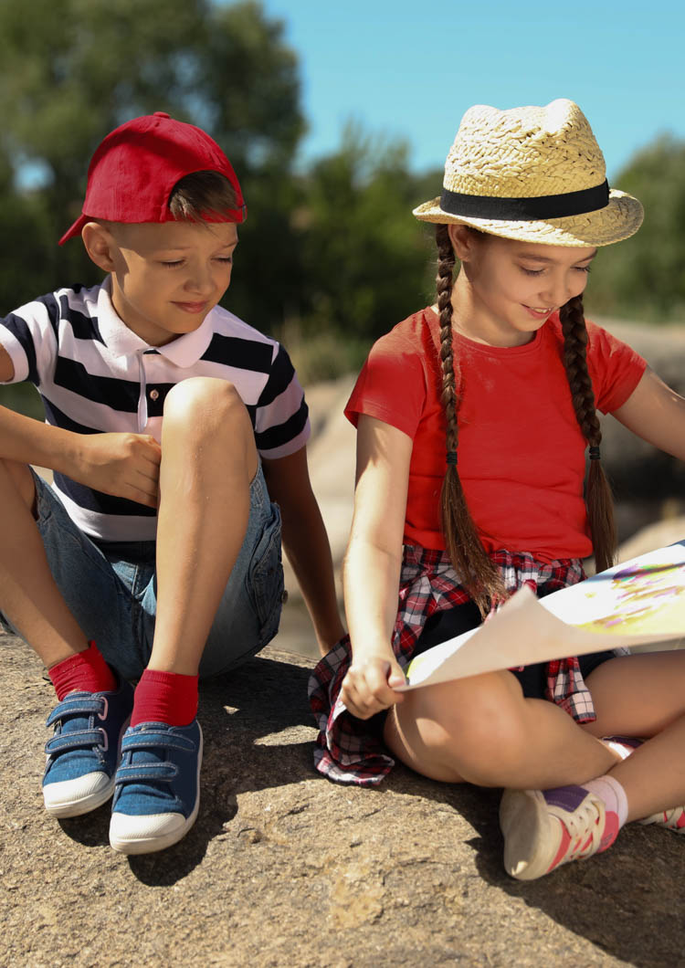Little children with map outdoors. Summer camp