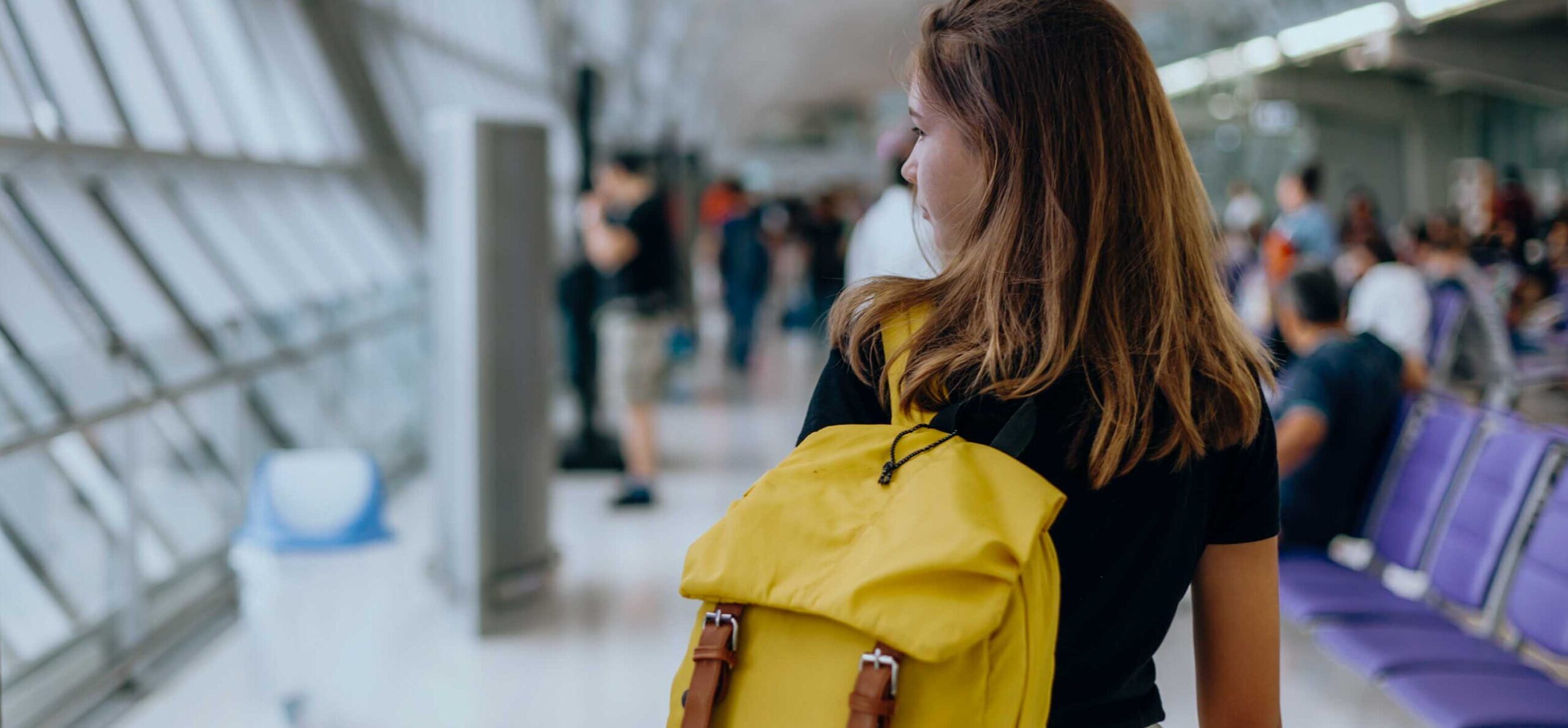 Teen girl waiting for international flight in airport departure