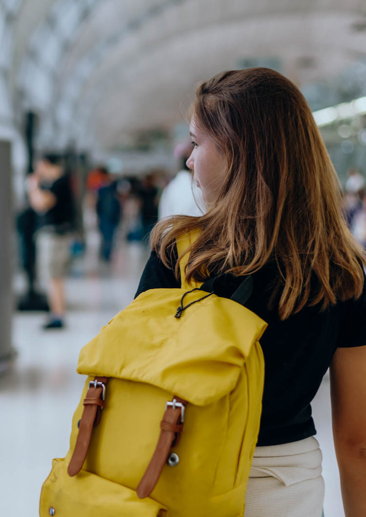 Teen girl waiting for international flight in airport departure